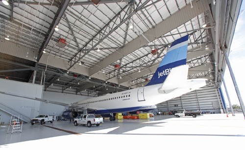 JetBlue aircraft inside a large steel aviation hangar built with Butler metal building systems.